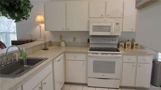 kitchen featuring a sink, white cabinetry, white appliances, and light countertops