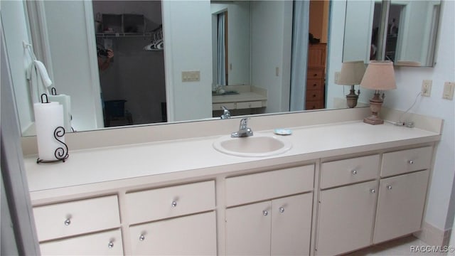 bathroom featuring vanity and a spacious closet