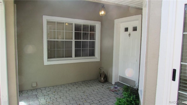 property entrance featuring stucco siding
