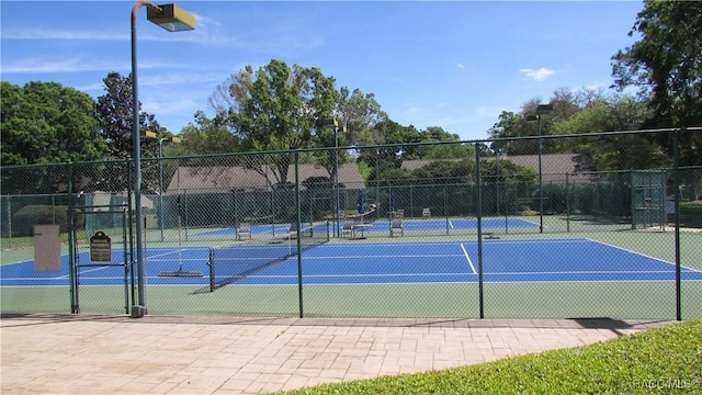 view of sport court featuring fence