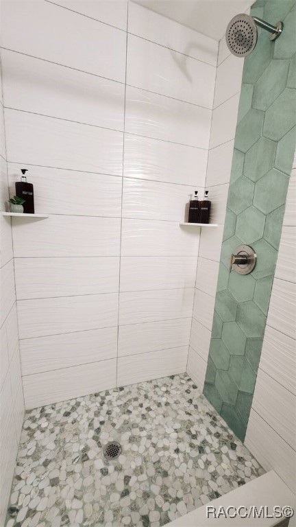 bathroom with tiled shower