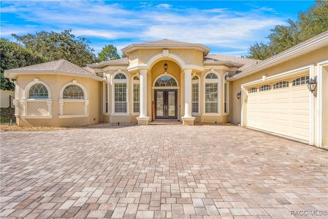 mediterranean / spanish-style home with french doors and a garage