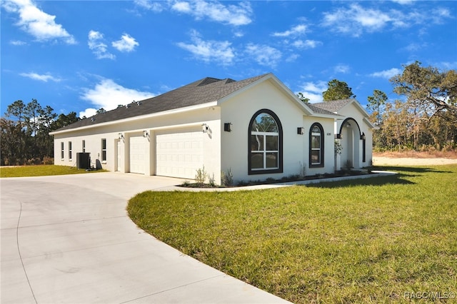 view of front of home with a front yard and a garage