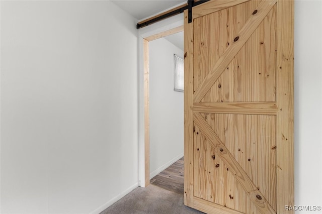 hallway featuring hardwood / wood-style floors and a barn door