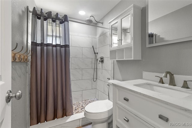 bathroom with a shower with curtain, toilet, and vanity