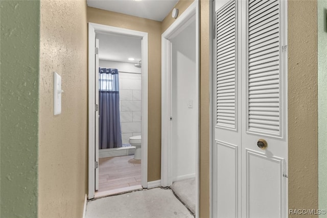 hallway with hardwood / wood-style floors