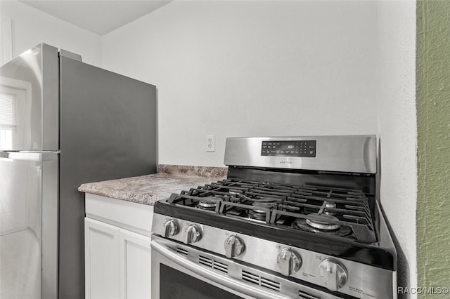 kitchen with white cabinetry and appliances with stainless steel finishes