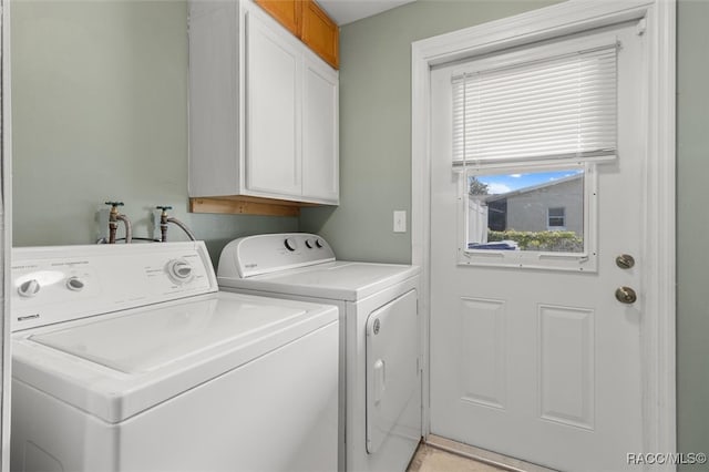 laundry room with cabinets and independent washer and dryer