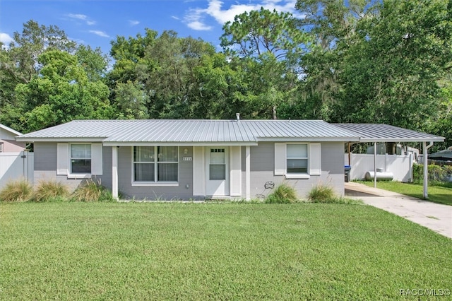 ranch-style house with covered porch, a carport, and a front lawn