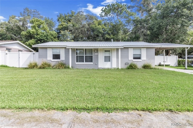 ranch-style house with a front yard and a carport