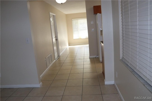 hall featuring light tile patterned floors