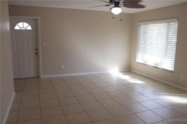 foyer with light tile patterned flooring, ceiling fan, and plenty of natural light