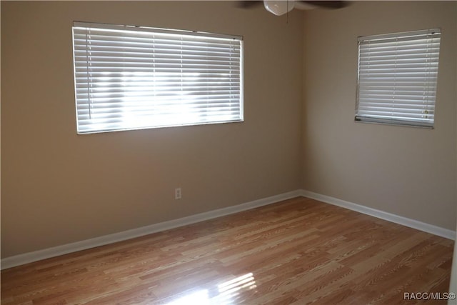 empty room featuring ceiling fan and light wood-type flooring