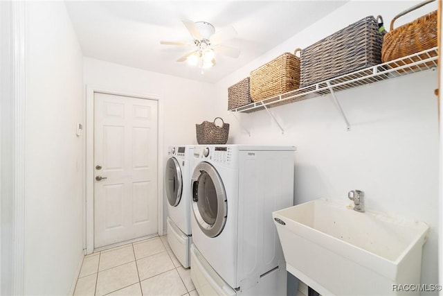 laundry area with washer and clothes dryer, ceiling fan, light tile patterned floors, and sink