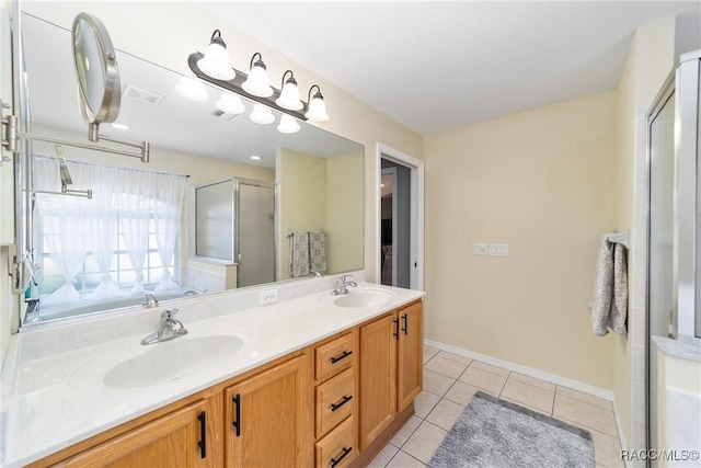 bathroom with tile patterned flooring, vanity, and a shower with shower door