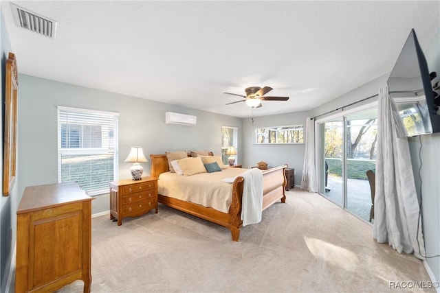 carpeted bedroom with a wall mounted air conditioner, ceiling fan, and access to exterior