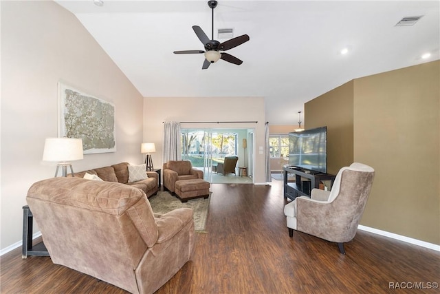 living room featuring ceiling fan, lofted ceiling, and dark wood-type flooring