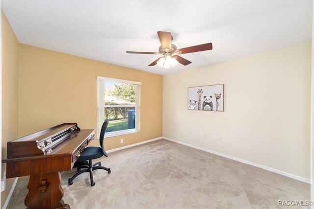 carpeted home office featuring ceiling fan