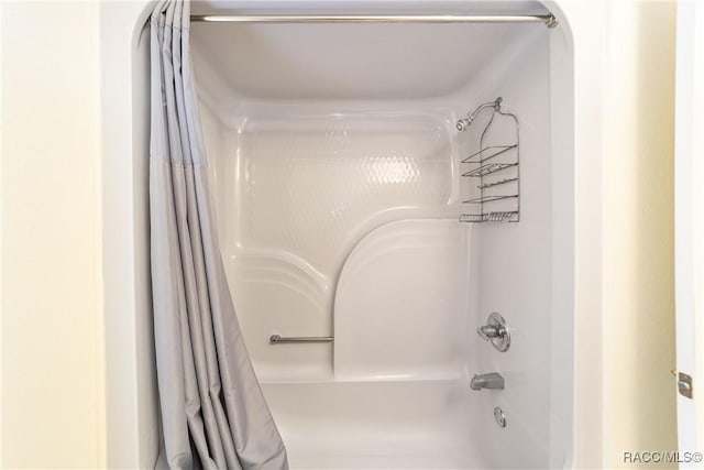 bathroom featuring shower / tub combo with curtain