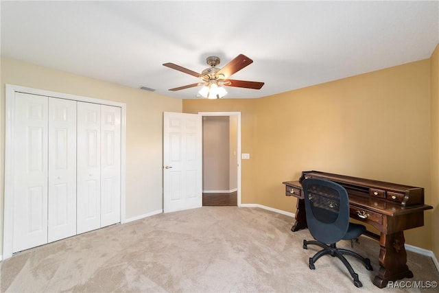 carpeted office with ceiling fan