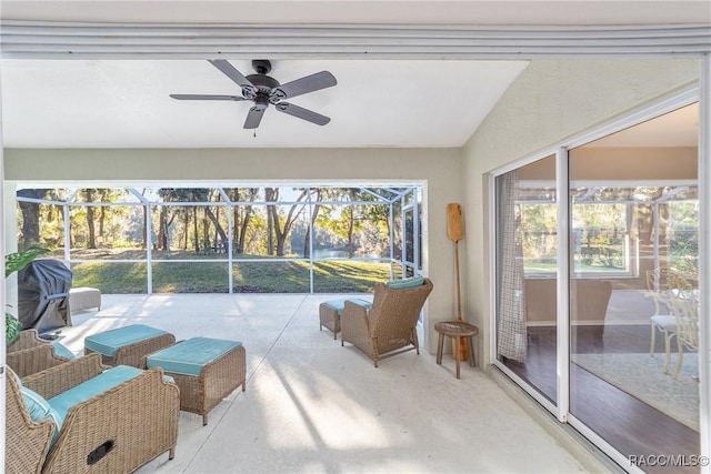 sunroom featuring ceiling fan and vaulted ceiling