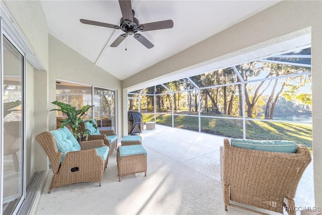 sunroom with ceiling fan and vaulted ceiling