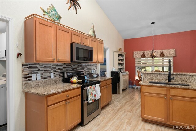 kitchen featuring sink, light hardwood / wood-style flooring, backsplash, pendant lighting, and appliances with stainless steel finishes