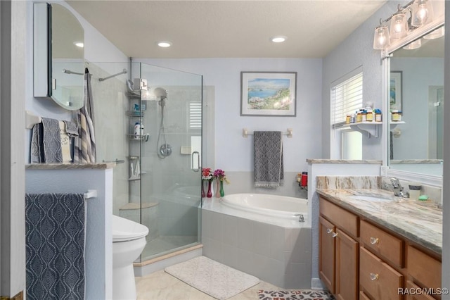 full bathroom featuring tile patterned flooring, vanity, toilet, and independent shower and bath