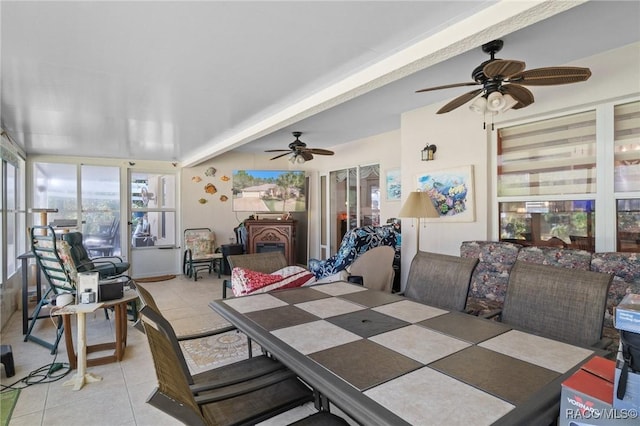 dining space featuring ceiling fan and light tile patterned floors