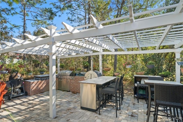 view of patio with a pergola, area for grilling, and an outdoor bar