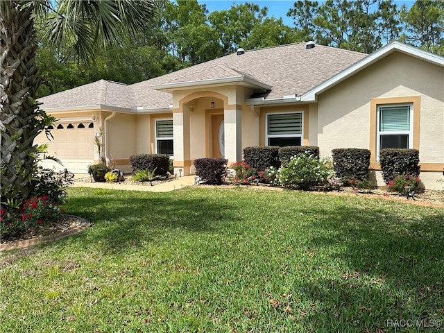 ranch-style house with a garage and a front lawn