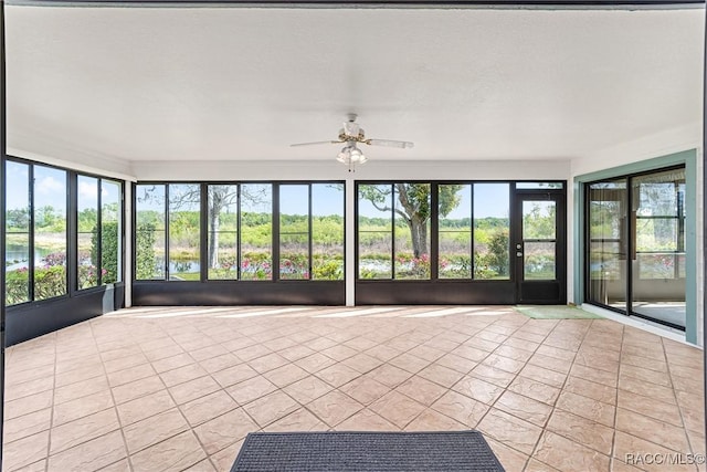unfurnished sunroom featuring tile patterned floors and plenty of natural light