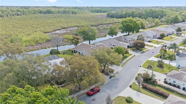 bird's eye view with a water view, a residential view, and a forest view