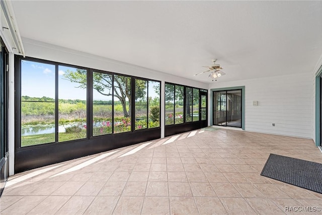 unfurnished sunroom featuring tile patterned floors and a ceiling fan