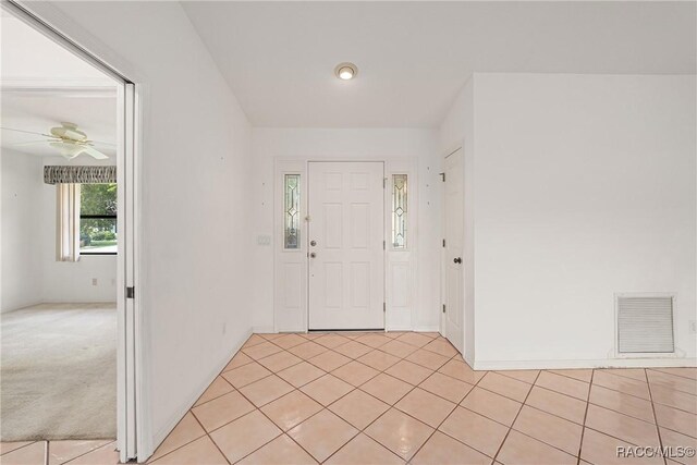 foyer featuring visible vents, ceiling fan, and light tile patterned flooring