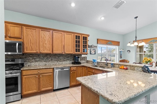 kitchen featuring appliances with stainless steel finishes, sink, backsplash, and plenty of natural light