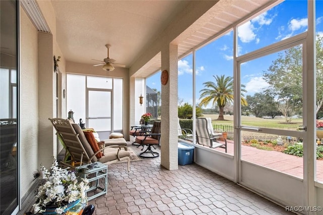 sunroom / solarium featuring ceiling fan