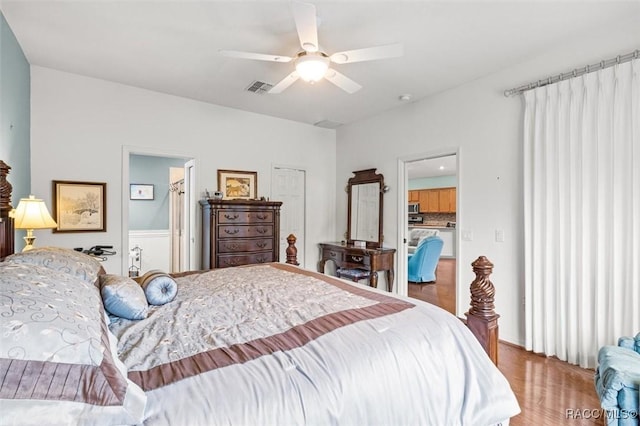 bedroom with hardwood / wood-style floors, a closet, and ceiling fan