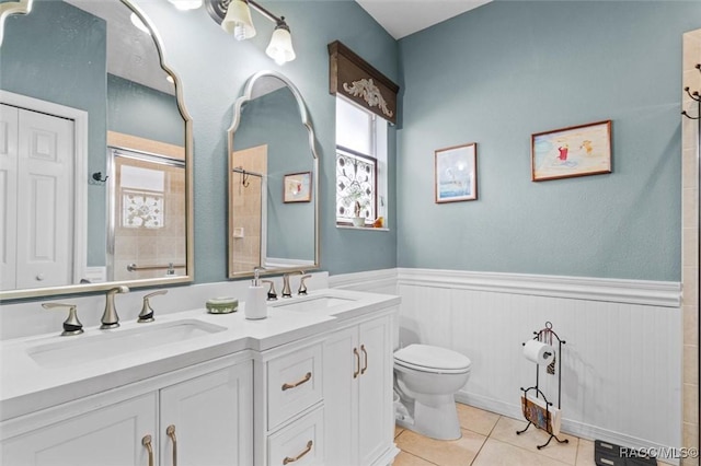 bathroom with tile patterned flooring, vanity, and toilet