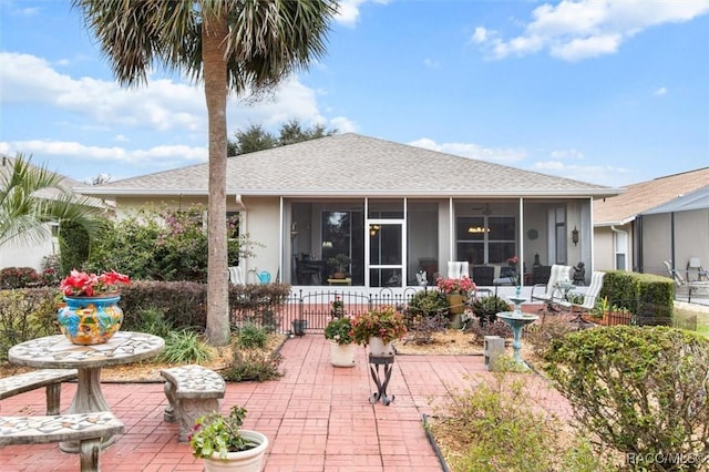 back of house featuring a sunroom