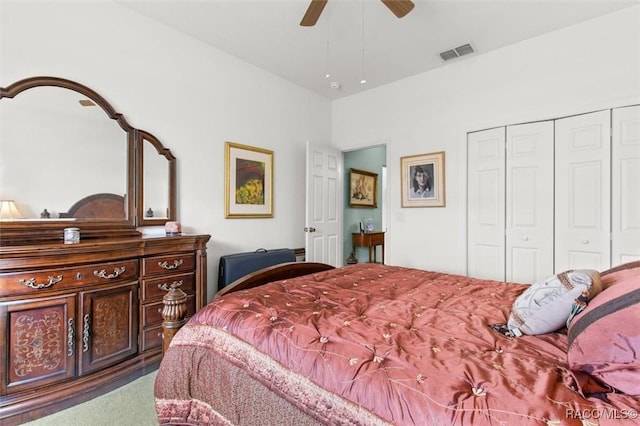 carpeted bedroom featuring ceiling fan and a closet