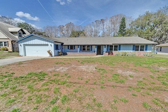 ranch-style home featuring a garage and a front lawn