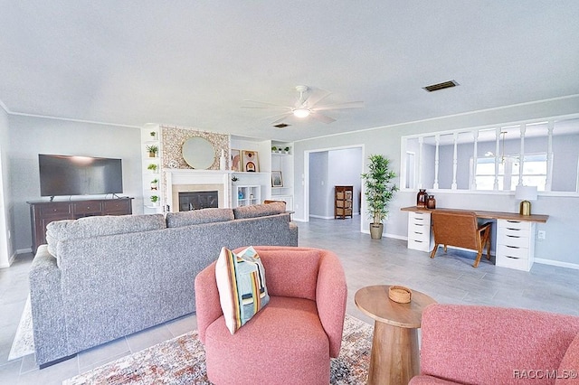 living room with light tile patterned flooring, ceiling fan, and built in features