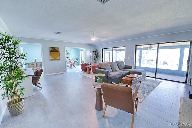 living room featuring a textured ceiling and ceiling fan