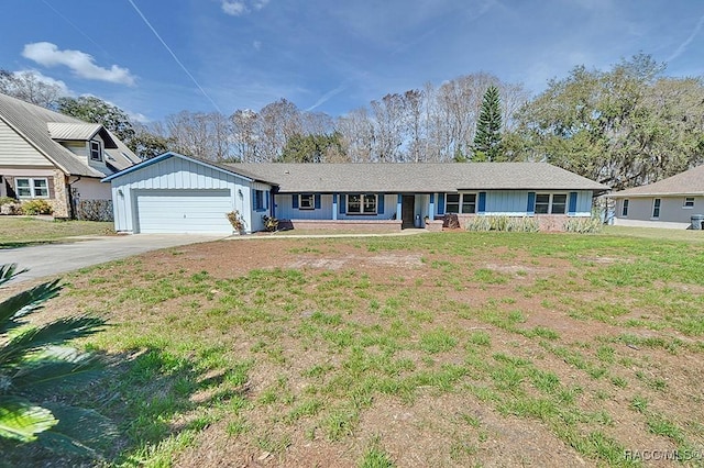 ranch-style home featuring a garage and a front lawn