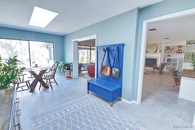 interior space featuring a skylight and a textured ceiling