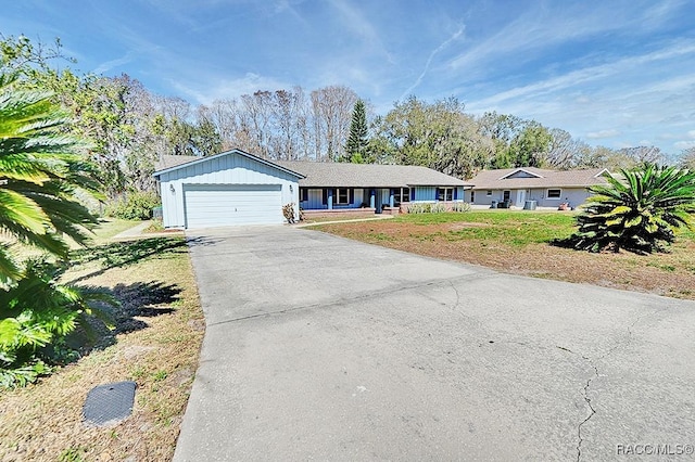 single story home with a garage and a front lawn