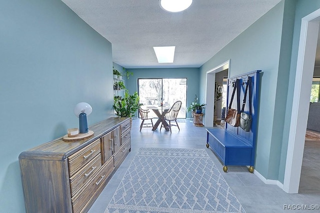 mudroom with a skylight and a textured ceiling