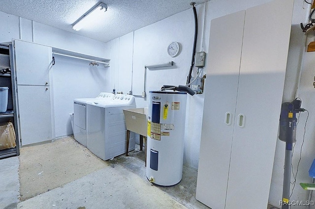 laundry area featuring washing machine and clothes dryer, water heater, and a textured ceiling