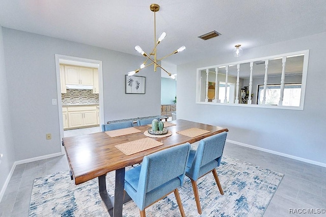 dining area with an inviting chandelier